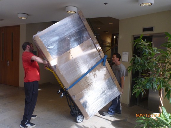 Movers transporting large furniture items